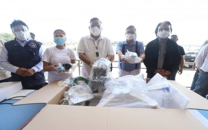 <p><strong>MEDICAL ASSISTANCE</strong>. Presidential Spokesperson Harry Roque (center) leads the ceremonial turnover of medical equipment and personal protective equipment (PPE) sets to the Iloilo City Government through Mayor Jerry P. Treñas (second from right) held at the Freedom Grandstand on Thursday (July 1, 2021). They were joined by (left to right) DOH Western Visayas Center for Health Development (DOH WV CHD) regional director Adriano P. Subaan, Iloilo City Lone District Rep. Julienne Baronda and Health Undersecretary Leopoldo Vega. <em>(Photo courtesy of Arnold Almacen/City Mayor’s Office)</em></p>
