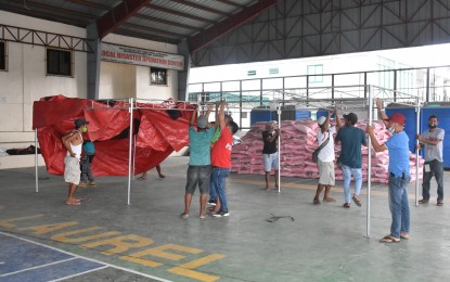 <p><strong>TEMPORARY SHELTER.</strong> Tents are being set up in a multipurpose center in Laurel, Batangas on Friday (July 2, 2021). The Department of Social Welfare and Development said 416 families or 1,712 individuals are currently staying in 16 evacuation centers in the province. <em>(Photo courtesy of Batangas-PIO)</em></p>