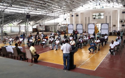 <p><strong>CASH AID</strong>. A total of 82 former rebels are shown receiving P20,000 each as additional cash aid from the government at the Davao Oriental Provincial Capitol covered court on Wednesday (July 7, 2021). The amount represents additional assistance under the Livelihood Settlement Grant Program of the Department of Social Welfare and Development (DSWD). <em>(Photo courtesy of Davao Oriental PIO)</em></p>