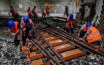 <p><strong>NEW RAIL SLEEPERS.</strong> Workers of the Metro Rail Transit Line 3 (MRT-3) install new fiber-reinforced foamed urethane (FFU) sleepers in select parts of the tracks at its depot on Thursday (July 8, 2021). The MRT-3 said 581 pieces of FFU sleepers will be installed at the depot.<em> (Photo courtesy of MRT-3)</em></p>
