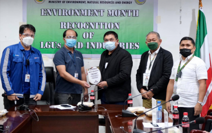 <p><strong>ENVIRONMENT-FRIENDLY FIRM.</strong> Cotabato Light and Power Company representatives Delbert C. Gonzales (left) and Anthony M. Bueno (2nd from left) receive the Plaque of Recognition on behalf of the company’s compliance with major environmental laws from BARMM Environment Minister Abdulraof A. Macacua as others acted as witnesses at the BARMM government center in Cotabato City on Wednesday (July 7, 2021). Two other business firms and three LGUs in the region were also recognized for their adherence to environmental laws in the same event. <em>(Photo courtesy of MENRE-BARMM)</em></p>