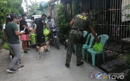 <p><strong>FOOD AID DISTRIBUTION</strong>. Authorities and barangay officials distribute food packs to families in high-risk barangays in San Fernando City in La Union on July 7, 2021. These high-risk barangays have been placed under granular lockdown to stop the spread of coronavirus disease 2019.<em> (Photo courtesy of San Fernando City's Facebook page)</em></p>