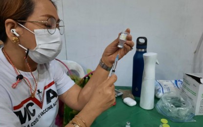 <p><strong>FRONT-LINER.</strong> Manila Health Department nurse Jing Herrera carefully prepares the Covid-19 vaccine to be administered at the San Andres Sports Complex on Thursday (July 8, 2021). She said nurses and doctors get tired but errors are isolated cases as they think of nothing but providing quality service. <em>(PNA photo by Marita Moaje)</em></p>