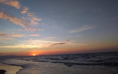 <p><strong>BONUAN TONDALIGAN</strong>. Sunset at the Bonuan Tondaligan Beach in Dagupan City. Residents and tourists can now swim and enjoy the beach's view as the city government lifted the no swimming policy on Friday (July 9, 2021). <em>(Photo courtesy of Heidi Martin Biason)</em></p>