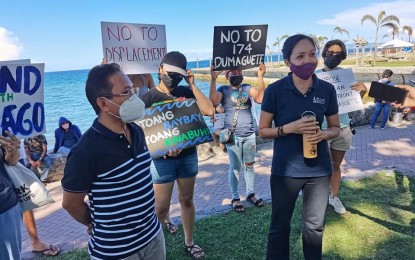 <p><strong>NO TO RECLAMATION</strong>. Gary Rosales and Aidalyn Arabe of the environmental advocacy group, Kinaiyahan, lead a peaceful assembly on Sunday (July 11, 2021) at the Rizal Boulevard in Dumaguete City. The activity aimed to collect signatures to show opposition to a multi-billion-peso reclamation project covering most of the city's shoreline. <em>(Photo by Judy Flores Partlow)</em></p>