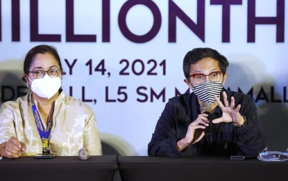 <p><strong>POPULATION PROTECTION.</strong> Mandaluyong City Mayor Carmelita Abalos (left) and National Task Force (NTF) against Covid-19 deputy chief implementer Secretary Vince Dizon (right) attend a media briefing at the SM Megamall in Mandaluyong on Wednesday (July 14, 2021). Dizon said the government is not changing its target to achieve population protection within this year.<em> (PNA photo by Joey Razon)</em></p>