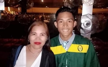 <p><strong>SHATTERED DREAM.</strong> Vilma Absalon with her son Kieth in this undated photo. The New People’s Army cut short his promising athletic career when the rebels’ anti-personnel mine planted on a roadside in Masbate City exploded while he was cycling with his relatives and friends on June 6. <em>(Photo courtesy of Vilma Absalon Facebook)</em></p>