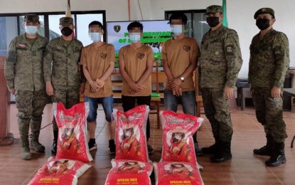 <p><strong>SURRENDER.</strong> Three members of the Abu Sayyaf Group receive sacks of rice, among other assistance, after their surrender in Indanan, Sulu on Wednesday (July 14, 2021). Financial problems were one of the reasons cited by a surrenderer on why he became a bandit at the age of 17. <em>(Photo courtesy of 11ID-PAO)</em></p>