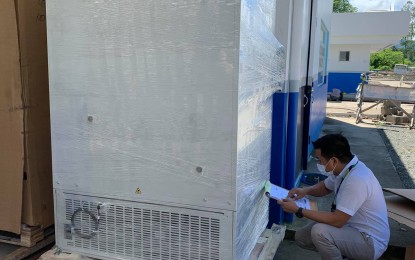 <p><strong>NEW STORAGE FACILITIES</strong>. Personnel from Butuan City Medical Center inspects one of the two ultralow freezers intended to store Pfizer vaccines and which arrived on Wednesday (July 14, 2021). The PHP1.5-million freezers were procured by the city government of Butuan. <em>(Photo courtesy of Butuan City PIO)</em></p>