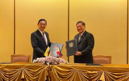 <p><strong>DOUBLE TAXATION PACT.</strong> Department of Finance (DOF) Secretary Carlos Dominguez of the Philippines and Yang Berhormat Dato Seri Setia Dr. Awang Haji Mohd Amin Liew bin Abdullah, the Minister at the Prime Minister’s Office and Minister of Finance and Economy II of Brunei Darussalam, hold their copies of the double taxation agreement they signed on behalf of their respective governments on July 16, 2021 in Brunei’s capital city of Bandar Seri Begawan. The Philippines-Brunei Agreement for the Avoidance of Double Taxation and the Prevention of Fiscal Evasion With Respect To Taxes on Income aims to further ease trade in goods and services, and enhance investment flows and economic activity between the countries. <em>(Photo courtesy of DOF)</em></p>