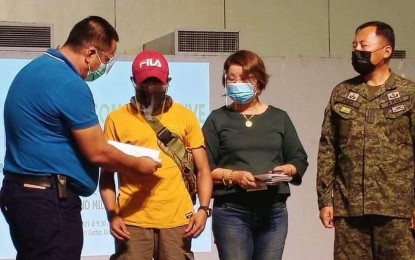 <p><strong>NEW LIFE.</strong> Negros Oriental Gov. Roel Degamo (left) hands over financial assistance to a rebel returnee in this undated photo. The government's Enhanced Comprehensive Local Integration Program has handed out more than P1.3 million in financial and livelihood assistance to 42 former members of the Communist Party of the Philippines-New People’s Army so far this year. <em>(Photo courtesy of the Philippine Army)</em></p>