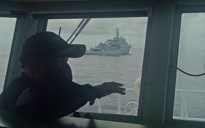<p><strong>CHASED AWAY</strong>. An officer of the Philippine Coast Guard (PCG) aboard BRP Cabra while chasing away a Chinese Navy warship from the Marie Louise Bank in the West Philippine Sea on July 13, 2021. President Rodrigo Duterte agreed Monday (July 19) that the mended relationship between the Philippines and China has made it “very easy” to ask Chinese ships to leave Philippine waters. <em>(Photo courtesy of PCG)</em></p>