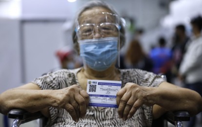 <p><strong>PROTECTED.</strong> A senior citizen fro Pasig City shows her vaccination card after getting inoculated with the single-shot Janssen vaccine. Persons who use fake vaccination cards face charges of falsification of documents, the Baguio City government warned. <em>(PNA photo by Joey Razon)</em></p>
<p><em> </em></p>
