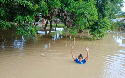 <p><strong>CHEST DEEP.</strong> Noraina Sansaluna, a resident of Sitio Malingco, Barangay Inug-ug, Pikit, North Cotabato shows Wednesday (July 21, 2021) how deep the flood is in her village. The flooding due to intermittent rains has affected 15,000 residents of three low-lying villages of the town. <em>(Photo courtesy of Noraina Sansaluna)</em></p>