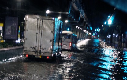 <p><strong>DOWNPOUR.</strong> Only large vehicles pass through the flooded Taft Avenue in Manila on Friday night (July 23, 2021). Heavy rains caused by the enhanced southwest monsoon drenched Metro Manila and many parts of Luzon for the past week. <em>(PNA photo by Jess Escaros Jr.)</em></p>