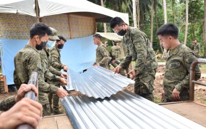 <p><strong>CIVIC ACTION.</strong> Members of the Joint Task Force-Sulu turn over construction materials to the owners of two houses destroyed by the C-130 that crashed in Patikul, Sulu on July 4, 2021. The distribution activity on Friday (July 23) was combined with free medical checkup and haircut for affected residents of Sitio Amman in Barangay Bangkal. <em>(Photo courtesy of JTF-Sulu)</em></p>