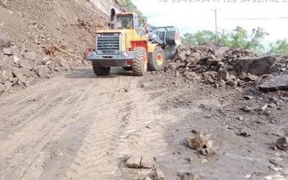 <p><strong>ROAD CLOSED</strong>. A team from the Department of Public Works and Highways clears the Manila North Road in Barangay Pancian, Pagudpud, Ilocos Norte on Sunday (July 25, 2021) following a major landslide. Ilocos region is likely to continue experiencing moderate to heavy rainfall in the next 24 hours, according to the state weather bureau. <em>(Photo courtesy of DPWH-Region 1)</em></p>