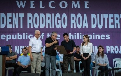 <p><strong>P3 LENDING PROGRAM</strong>. President Rodrigo Duterte and Trade Secretary Ramon Lopez (center) during the launch of Pondo sa Pagbabago at Pag-Asenso or P3 Program in Tacloban in 2017. The P3 program provides low interest rate lending for small-scale businesses. <em>(Photo courtesy of DTI)</em></p>