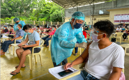 <p><strong>OFW LANE</strong>. Overseas Filipino workers (OFWs) get a priority lane in the mass vaccination program of Laoag City government on Monday (July 26, 2021). Some 4,870 doses of Janssen vaccines are expected to be rolled out for residents from July 26 to 31. (<em>PNA photo by Leilanie G. Adriano</em>) </p>