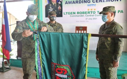 <p><strong>AWARD</strong>. Lt. Gen. Roberto Ancan (left), commander of the Armed Forces Central Command, fastens the campaign streamer of the 79th Infantry Battalion in recognition of its dismantling of the Northern Negros Front of the New People’s Army in the presence of Col. Michael Samson (center), deputy commander of 303 Infantry Brigade, and Lt. Col. J-jay Javines, commander of 79IB. The rites were held at the battalion headquarters in Barangay Bato, Sagay City, Negros Occidental on Tuesday (July 27, 2021). <em>(Photo courtesy of 79IB, PA)</em></p>