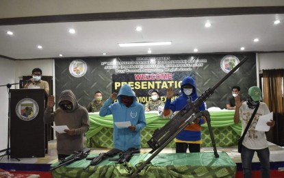 <p><strong>RIGHT PATH</strong>. Four heavily armed members of the extremist group Bangsamoro Islamic Freedom Fighters (BIFF) take an oath of allegiance to the Philippine flag after they surrendered on Tuesday (July 27, 2021) to military authorities in Ampatuan, Maguindanao. Seven others (not in photo) surrendered to military authorities in the town of Datu Anggal Midtimbang in the same province. <em>(Photo courtesy of the 1st Mechanized Infantry Battalion)</em></p>
