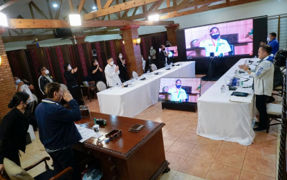 <p><strong>VIRTUAL COURTESY CALL</strong>. President Rodrigo Roa Duterte returns the salute of weightlifter and airwoman Hidilyn Diaz, who won the country's first Olympic gold medal, during a video call at the Malago Clubhouse in Malacañang Park on July 28, 2021. President Duterte told  Diaz that she will be awarded with the Medal of Merit, fully furnished house and lot in Zamboanga City and P3-million aside from the P10-million incentive provided by law. <em>(Presidential photo by King Rodriguez)</em></p>