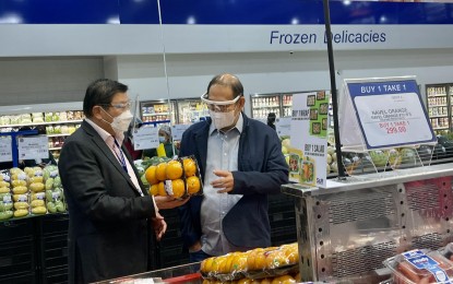 <p><strong>BOOSTING LOCAL ECONOMY.</strong> Marikina Mayor Marcelino Teodoro (right) gets a tour of the SnR Membership Shopping branch in the city from SnR president Anthony Sy (left) during the store's opening on Thursday (July 29, 2021). The store will employ around 200 residents. <em>(Photo courtesy of Marikina PIO)</em></p>