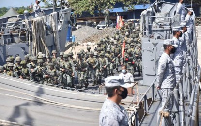 <p><strong>REDEPLOYED.</strong> Troops of the Marine Battalion Landing Team-1 (MBLT-1) board a Philippine Navy vessel on Thursday (July 29, 2021) at the port of Luuk, Sulu en route to their new place of assignment in the province of Tawi-Tawi. The MBLT-1 was assigned to fight the Abu Sayyaf Group in Sulu more than five years ago.<em> (Photo courtesy of the Joint Task Force (JTF)-Sulu Public Affairs Office)</em></p>