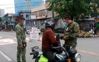 <p><strong>CHECKPOINT.</strong> Members of Kamuning Police Station 10 conduct random inspections at the corner of Mother Ignacia Avenue and Scout Borromeo Street in Barangay South Triangle, Quezon City on Saturday morning (July 31, 2021). Quarantine control points have also been set up Sunday (Aug. 1, 2021) at the borders of the National Capital Region Plus. <em>(Photo courtesy of Kamuning Police Facebook)</em></p>