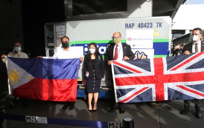 <p><strong>UK DONATION.</strong> Vaccine czar Secretary Carlito Galvez Jr. and British Ambassador Daniel Pruce (2nd and 4th from left) welcome the arrival of 415,040 doses of AstraZeneca vaccine at the Ninoy Aquino International Airport Terminal 3 in Pasay City on Monday (Aug. 2, 2021). The jabs were donated by the United Kingdom. <em>(PNA Photo by Avito Dalan)</em></p>