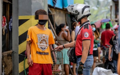 <p><strong>REMINDERS.</strong> Members of Quezon City’s Department of Public Order and Safety and Task Force Traffic and Transport Management go around residential areas, roads, and markets in Barangay Pinyahan on Monday (Aug. 2, 2021). They reminded residents to wear their masks properly to avoid paying fines of PHP300 (first offense), PHP500 (second offense), and PHP1,000 (third offense). <em>(Photo courtesy of QC Government)</em></p>