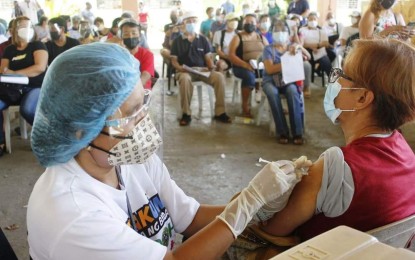 <p><strong>INOCULATED</strong>. An elderly woman gets vaccinated against the coronavirus disease 2019 (Covid-19) at the Education and Training Center School cluster on August 2, 2021. On Wednesday (Aug. 4, 2021), the Bacolod City Emergency Operations Center-Task Force warned the public of the health risks posed by getting inoculated with different brands of Covid-19 vaccine.<em> (Photo courtesy of Bacolod City PIO)</em></p>