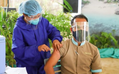 <p><strong>PROTECTING TOURISM WORKERS.</strong> A tourism worker receives his first dose of Covid-19 vaccine during the mass vaccination for tourism front-liners and workers in El Nido, Palawan on Aug. 3, 2021. The tourist destinations that will be prioritized by the DOT are El Nido, Coron, and San Vicente, Palawan; Puerto Princesa City, and Siargao. (DOT photo)</p>