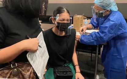 <p><strong>PROTECTED.</strong> Celebrity Maine Mendoza (center) gets her first shot of the Covid-19 vaccine in Mandaluyong City on June 2021. Health officials say it helps that influencers promote the importance of vaccination. <em>(Photo courtesy of Maine Mendoza Instagram)</em></p>