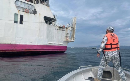 <p><strong>IN QUARANTINE</strong>. Personnel of the Philippine Coast Guard (PCG) monitors Roll-on, Roll-off vessel St. Anthony de Padua of 2GO anchored off Bauan Bay in Batangas on Monday (Aug. 9, 2021). The PCG said 28 out of the 82 crew members of the vessel have been tested positive for Covid-19 and have been isolated and quarantined. <strong><em>(Photo courtesy of PCG)</em></strong></p>