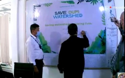 <p><strong>CONSERVATION</strong>. A representative of the Department of Environment and Natural Resources (DENR) in Western Visayas signs its commitment and support to the "Save our Watershed"  (SOW) campaign on Tuesday (Aug. 10, 2021). SOW aims to help sustain and conserve watersheds in the country.<em> (Screenshot from virtual launching) </em></p>