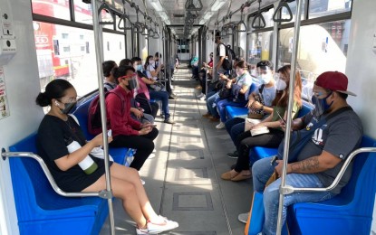 <p>Passengers wearing face masks inside an MRT-3 train. <em>(PNA file photo) </em></p>