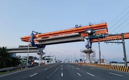 <p><strong>GIRDER INSTALLATION.</strong> The installation of a girder for the Light Rail Transit Line 1 (LRT-1) Cavite Extension project along the Manila-Cavite Expressway. Once completed, the project is seen to reduce travel time between Baclaran and Bacoor, Cavite from 1 hour and 10 minutes to just 25 minutes and increase passenger capacity from 500,000 to 800,000 daily. <em>(Photo courtesy of Dmitri Valencia)</em></p>