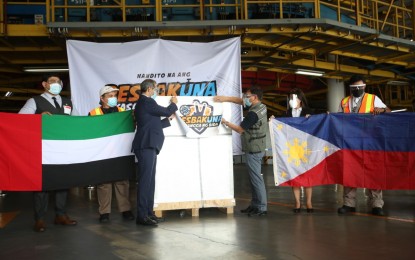 <p><strong>NEW VAX BRAND</strong>. Acting Chargé Affaires of UAE Khalid Alhajeri (3rd from left) and NTF's sub-task group on current operations head and OPAPP Assistant Secretary Wilben Mayor (3rd from right) put the Department of Health's campaign "Resbakuna" sticker on the Sinopharm/Hayat-vax Covid-19 vaccine cargo that arrived at NAIA Terminal 3 in Pasay City on Wednesday (Aug. 11, 2021). Mayor said the latest delivery will be deployed to various priority areas. <em>(PNA photo by Avito Dalan)</em></p>