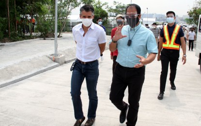 <p><strong>MEGA VAX SITE.</strong> National Task Force Against Covid-19 chief implementer Secretary Carlito Galvez Jr. together with International Container Terminal Services, Inc. Executive Vice President Christian Gonzalez during a visit at the Solaire-ICTSI Mega Vaccination Center on Thursday (Aug. 12, 2021). The site, located along New Seaside Drive in Parañaque City, hosts eight ambulatory vaccination centers and 30 drive-thru booths that have the capacity to inoculate at least 15,000 persons a day. <em>(PNA photo by Jesus Escaros)</em></p>