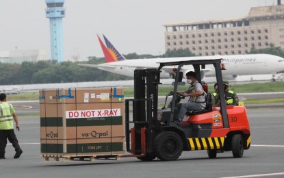 <p><strong>AMERICAN-MADE.</strong> The Singapore Airlines carrying 469,200 doses of the Moderna Covid-19 vaccine lands at Terminal 3 of the Ninoy Aquino International Airport in Pasay City on Sunday (Aug. 15, 2021). Of the total, 319,200 doses of the US-made jab were procured by the Philippine government while 150,000 were purchased by the private sector. <em>(PNA photo by Avito Dalan)</em></p>