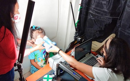 <p><strong>YOUNG APPLICANT.</strong> A young girl applying for a Philippine Identification card has her iris scanned at a registration center in Alegria, Cebu in this undated photo. Fingerprint scan and photographs are also recorded during the Step 2 process. <em>(Photograph courtesy of PhilSys Alegria Facebook)</em></p>