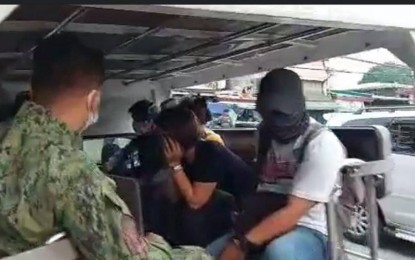 <p><strong>ARRESTED.</strong> Police nab fixers who allot pandemic cash assistance to unqualified beneficiaries in Barangay Kalawaan, Pasig City on Thursday (Aug. 19, 2021). Eighteen persons were arrested during the entrapment operation, including seven residents and two subsidy validators. <em>(Screengrab from Mayor Vico Sotto Facebook)</em></p>