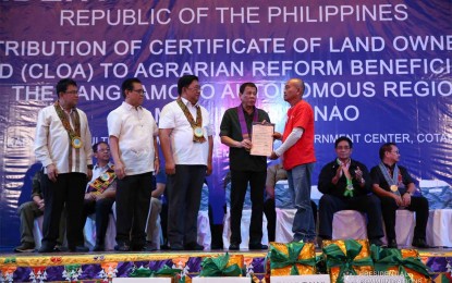<p><strong>CONTINUING EFFORTS.</strong> President Rodrigo Duterte leads the distribution of the Certificates of Land Ownership Award to qualified agrarian reform beneficiaries in the Bangsamoro Autonomous Region in Muslim Mindanao at Shariff Kabunsuan Cultural Complex in Cotabato City on Dec. 23, 2019. More land titles are set for distribution in October, particularly for residents displaced by the 2017 Marawi City siege. <em>(Presidential photo)</em></p>