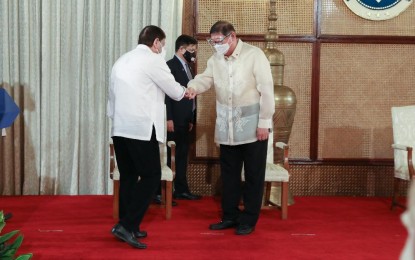 <p><strong>DOCTOR OF HUMANITIES</strong>. President Rodrigo Roa Duterte does a fist bump with Philippine Sports Commission chairman William Ramirez during the awarding of incentives to the medalists and other athletes who competed in the 2020 Tokyo Olympics at the Malacañang Palace on Aug. 23, 2021. The Mindanao State University-Marawi Campus on Wednesday (Sept. 29, 2021) conferred Doctor of Humanities honoris causa degree to Ramirez for his contribution to the Mindanao Sports for Peace movement. <em>(Presidential photo)</em></p>
