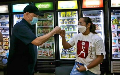 <p><strong>'TRAILBLAZER' HIDILYN.</strong> San Miguel Corp. president Ramon Ang (left) and Hidilyn Diaz do the fist bump at the SMC office in Pasig City on Tuesday (Aug. 24, 2021). Ang called Diaz a game-changer after she ended the Philippines' 97-year search for its first Olympic gold in Tokyo. <em>(Photo grabbed from RSA's Facebook page)</em></p>