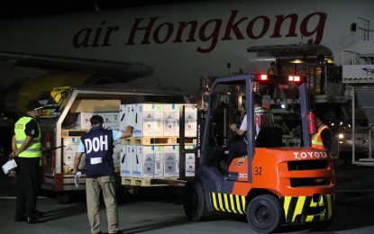 <p><strong>MORE LIFE-SAVING SHOTS.</strong> A Department of Health personnel checks the latest shipment of Pfizer vaccine at the NAIA on Wednesday (Aug. 25, 2021) night. The vaccine would be deployed in Covid-19 high-risk and vulnerable areas such as the National Capital Region and Region 4-A (Calabarzon) under the vaccination program's "focus and expand" strategy. <em>(PNA photo by Avito C. Dalan)</em></p>