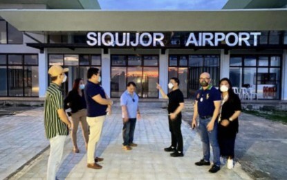 <p><strong>OCULAR VISIT.</strong> This April 2021 photo shows Office of the Presidential Assistant for the Visayas Undersecretary Anthony Gerard Gonzales (3rd from right) inspecting the upgrading work being done at the Siquijor Airport. The modern airport, seen to boost tourism in the province, will be unveiled on Thursday (Aug, 26, 2021). <em>(Photo courtesy of OPAV)</em></p>