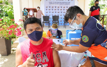 <p style="font-weight: 400;"><strong>VAX FOR TOURISM WORKERS.</strong> A tourism worker in Siargao gets his anti-Covid-19 shot on Friday (Aug. 27, 2021). As of August 25, a total of 833 tourism workers on the island have received their first dose of Sinovac vaccine through the rural health unit of the Department of Health. <em>(Photo courtesy of DOT)</em></p>