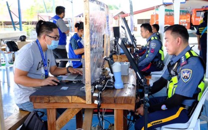 <p><strong>PRE-SUSPENSION.</strong> Davao City cops troop to a registration center to have their biometrics recorded for the Philippine Identification card in this March 2021 photo. The city government suspended face-to-face non-emergency essential government activities, including the national ID signup, from May until Aug. 31, 2021. <em>(Photo courtesy of Davao-CIO)</em></p>